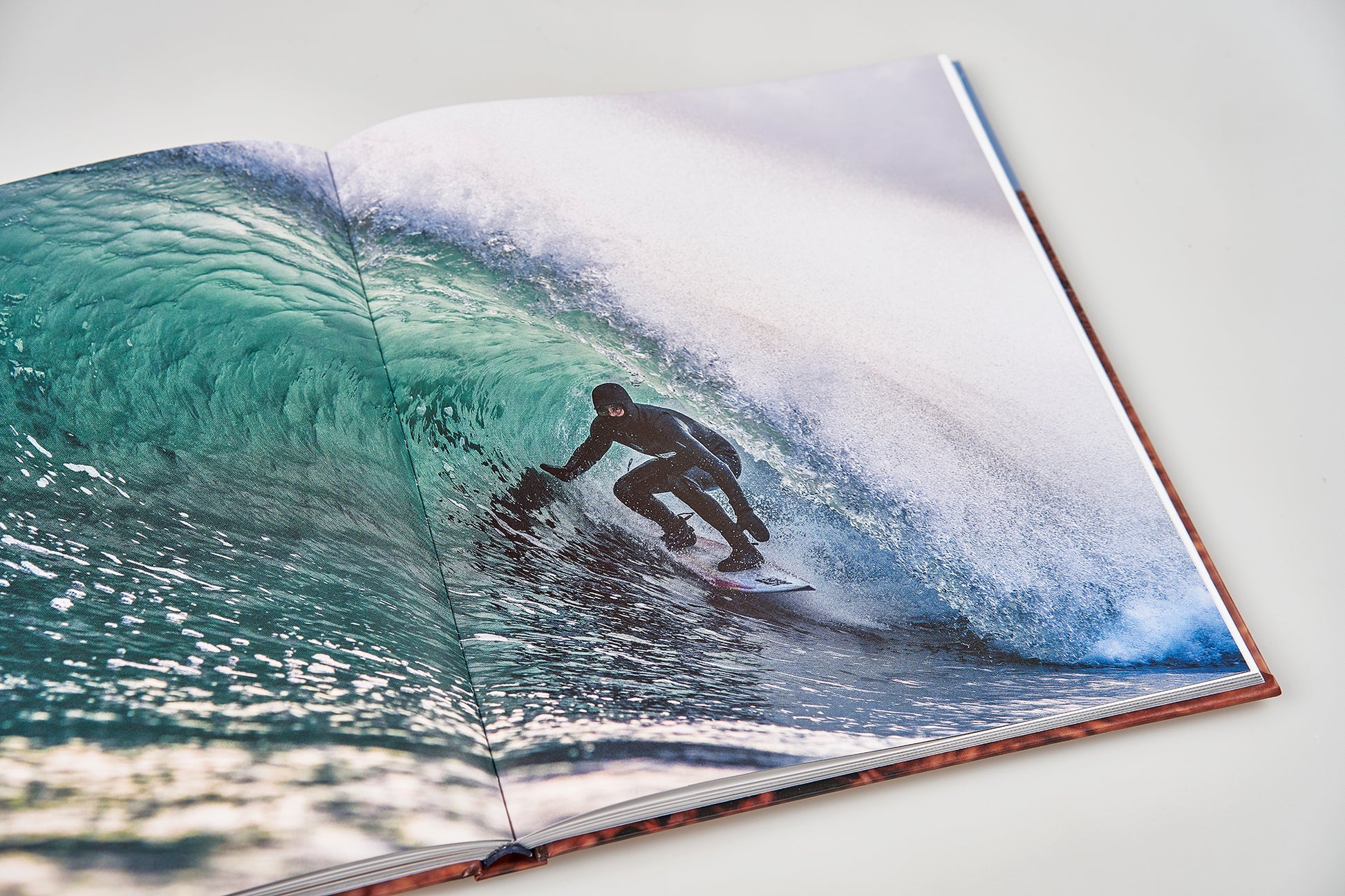 Island X- A photography book by Mark McInnis- Standard edition open to a surfing photo.