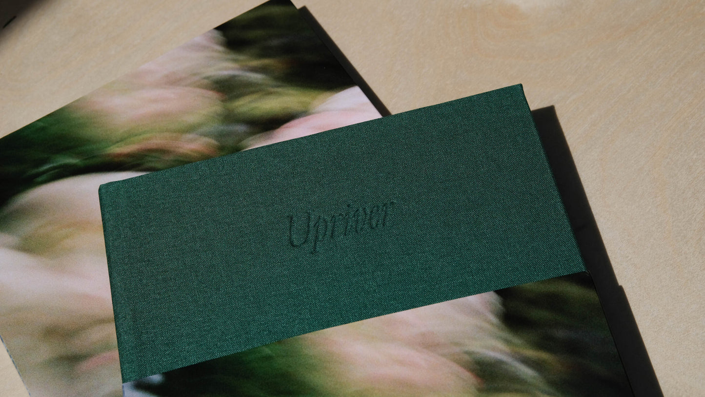 Upriver- A photography book by Mark McInnis- Zoomed in on front cover with slip cover on.