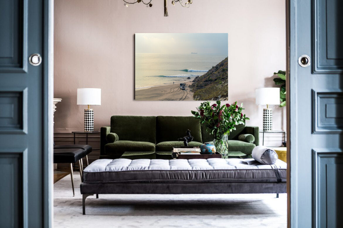 Early Bird's Feast- A photograph by Mark McInnis above a green couch.