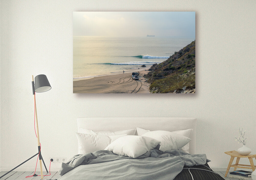 Early Bird's Feast- A photograph by Mark McInnis above a bed.