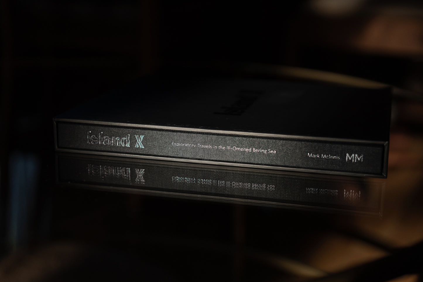 Island X- A photography book by Mark McInnis- Limited edition with fabric spine and black slip case- close up on the books spine.